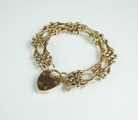 Lot 165 - A brick and cross link bracelet, the heart...