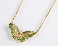Lot 167 - A diamond and emerald set butterfly pendant,...