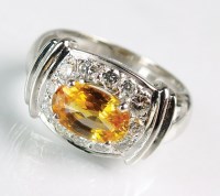 Lot 185 - An orange sapphire and diamond dress ring,...