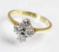 Lot 193 - An 18ct gold four stone diamond ring, designed...