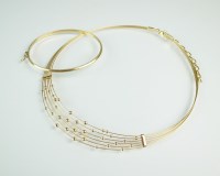 Lot 241 - A 14ct gold tapering collarette with bead...