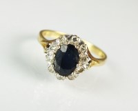 Lot 249 - An 18ct gold sapphire and diamond oval cluster...