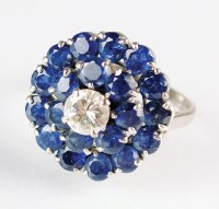 Lot 259 - A diamond and sapphire circular cluster ring,...