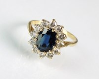 Lot 280 - An 18ct gold sapphire and diamond oval cluster...