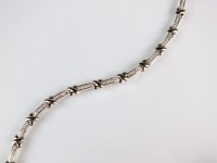 Lot 282 - A diamond tennis bracelet, designed as twelve...