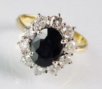 Lot 289 - An 18ct gold sapphire and diamond oval cluster...