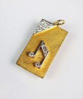 Lot 300 - An 18ct gold musical note diamond set pendant,...