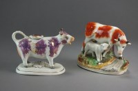 Lot 256 - A pearlware pink lustre cow creamer and cover,...