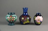 Lot 275 - A group of three small Moorcroft vases,...