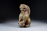 Lot 400 - A large Chinese green and russet jade figure...