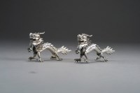 Lot 427 - A pair of Chinese silver dragon menu or place...