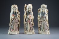 Lot 441 - Three Chinese stained ivory figures of Fu Lu...