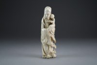 Lot 451 - A Chinese carved ivory figure of an immortal,...