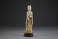 Lot 454 - A Chinese carved and stained ivory figure of a...