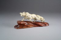 Lot 480 - A Japanese ivory okimono of wolves attacking a...