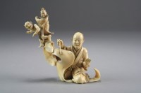 Lot 517 - A Japanese ivory okimono of a scroll painter,...