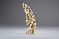 Lot 519 - A Japanese ivory okimono of street performers,...