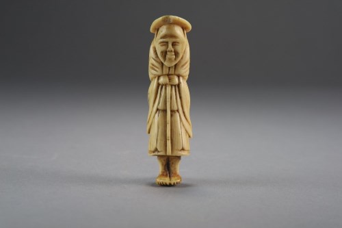 Lot 526 - A Japanese ivory netsuke, Edo period, carved...
