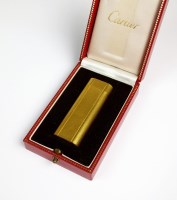 Lot 125 - A cased Cartier lighter, the engine turned...