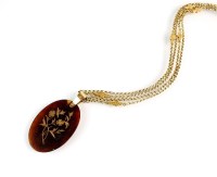 Lot 155 - An oval tortoiseshell pique work pendant,...