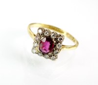 Lot 180 - A ruby and diamond cluster ring, designed as a...