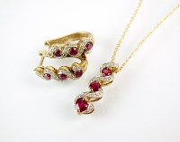 Lot 186 - A 9ct gold ruby and diamond cluster pendant on...