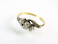 Lot 198 - A three stone diamond crossover ring, designed...