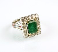 Lot 207 - An emerald and diamond cluster ring, designed...