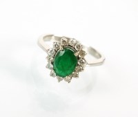 Lot 215 - An emerald and diamond oval cluster ring,...