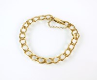 Lot 218 - A yellow metal flat curb link bracelet, with...