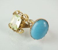 Lot 235 - An oval cabochon turquoise ring, claw set...