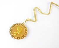 Lot 266 - A yellow metal Egyptian circular pendant,...