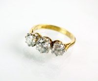 Lot 272 - A graduated three stone diamond ring, the...