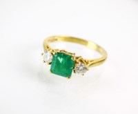 Lot 279 - An 18ct gold three stone emerald and diamond...