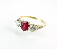 Lot 280 - An 18ct gold three stone ruby and diamond ring,...