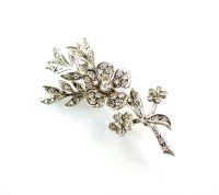 Lot 282 - A graduated diamond floral spray brooch, the...