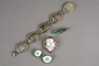 Lot 5 - A silver panel brooch, each oval plaque...