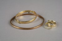 Lot 11 - A 9ct gold hollow slave bangle, weight 6g,...