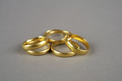 Lot 12 - Five 22ct gold wedding bands (one split),...