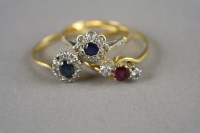 Lot 15 - A three stone ruby and diamond ring, the shank...