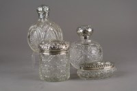 Lot 24 - Two silver topped glass circular bottles,...