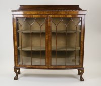 Lot 228 - A 1930s walnut veneered bow front display...