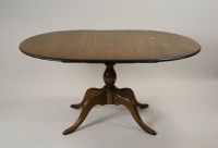 Lot 296 - An Ercol elm extending D-end pillar dining...