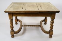 Lot 297 - A 1930s Carolean style oak draw leaf dining...