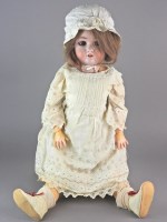 Lot 117 - A Jutta bisque head doll wearing dark blonde...