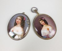 Lot 73 - Two oval ceramic plaque pendants, each...