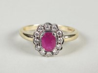 Lot 79 - A 9ct gold ruby and diamond oval cluster ring
