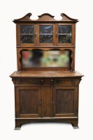 Lot 219 - An Edwardian oak mirror back side board in...