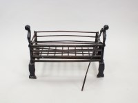 Lot 232 - A wrought iron dog grate, basket and liner in...