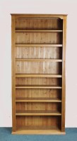 Lot 258 - A modern pine free standing bookcase, the...